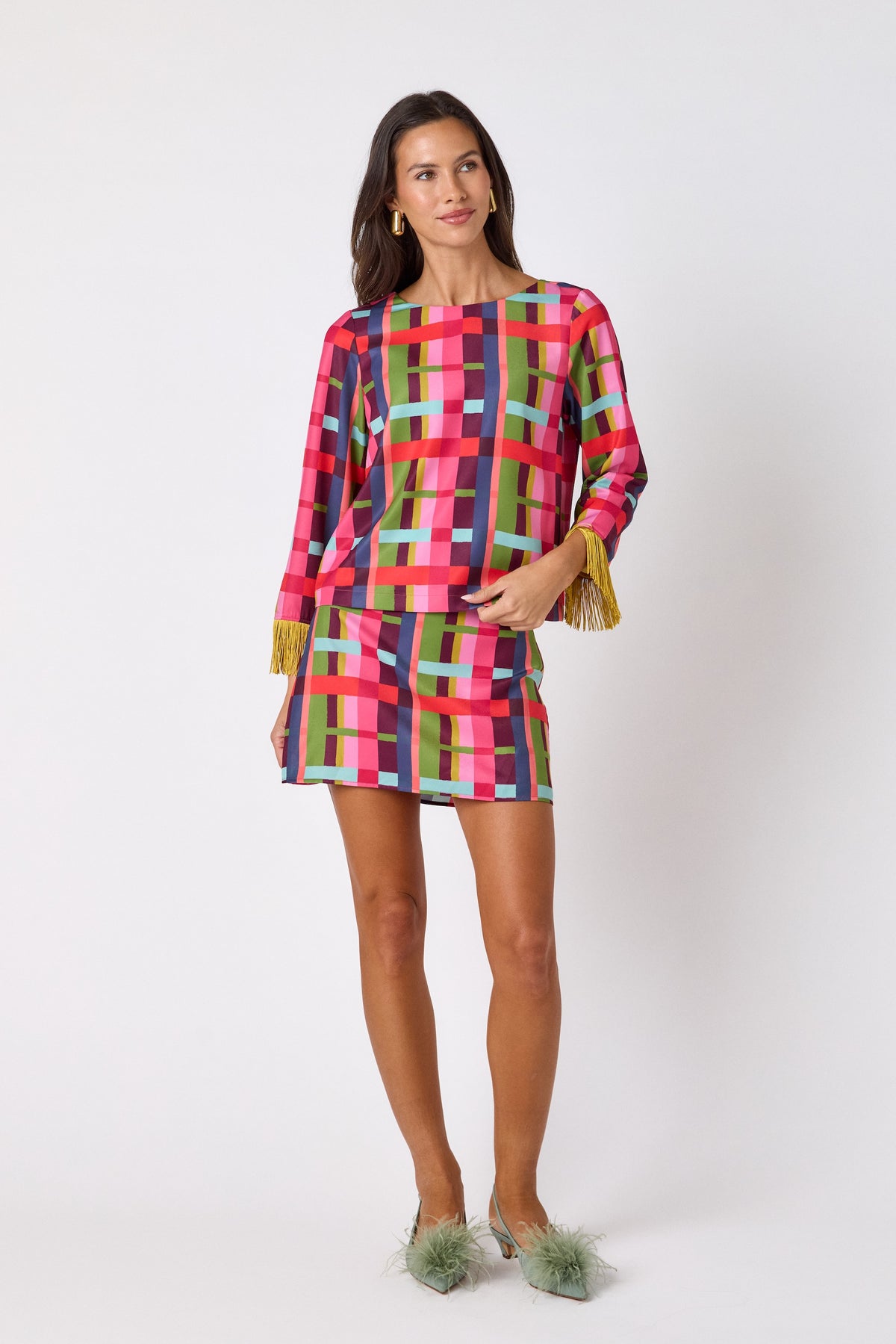 Maya Top in Plaid Parade featuring contrast fringe sleeve cuffs and back neck tie detailing on model – CROSBY by Mollie Burch