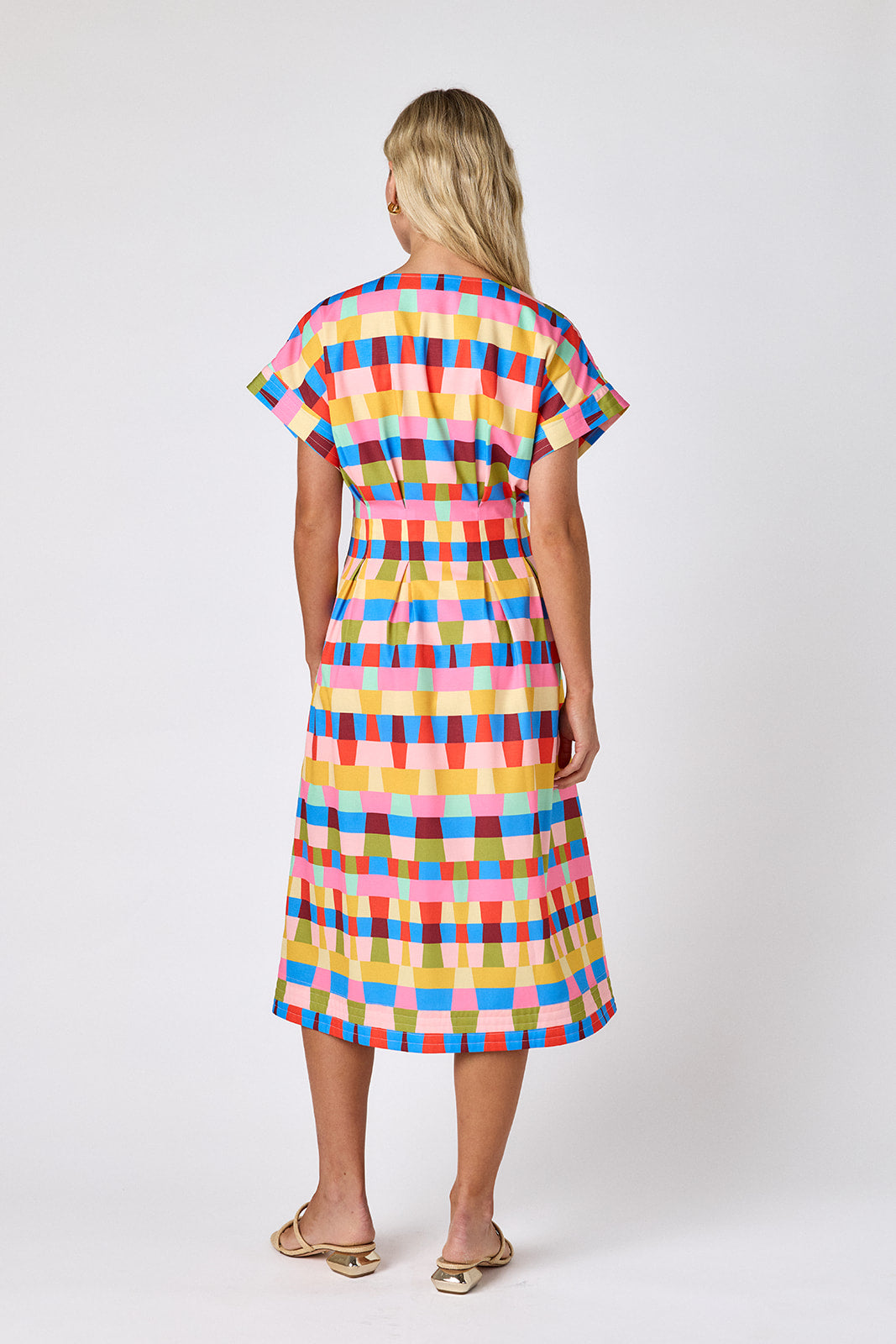 Prism short sleeved button-front midi dress with waist emphasis on model — CROSBY by Mollie Burch