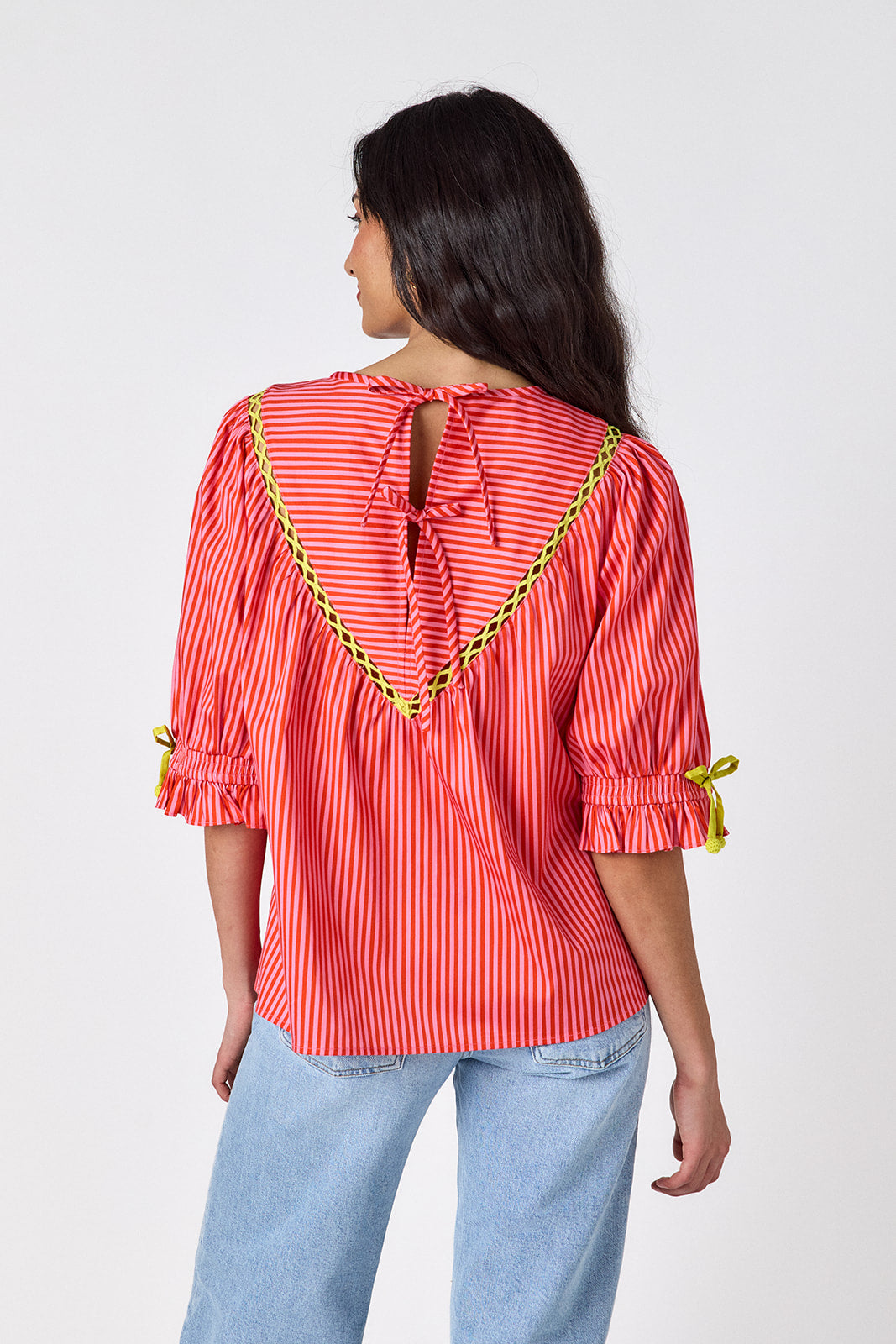 Orchid puff sleeve top with tie detail on model — CROSBY by Mollie Burch