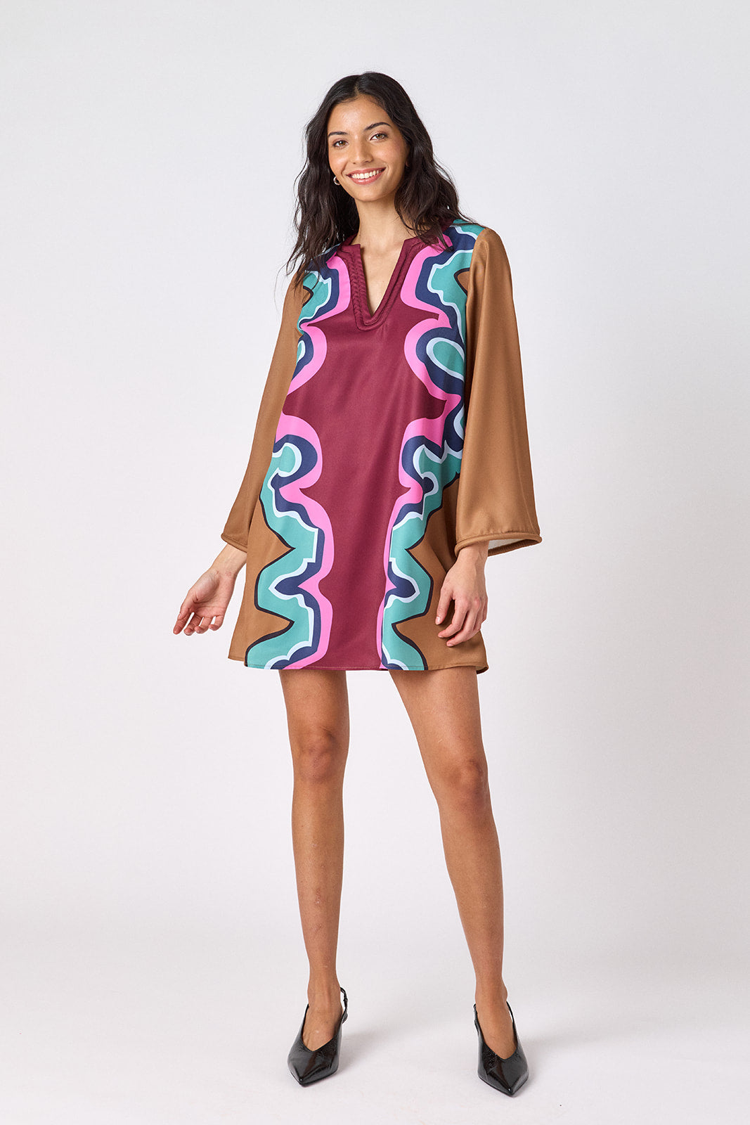 Serpentine above-the-knee tunic dress with bell sleeves on model – CROSBY by Mollie Burch