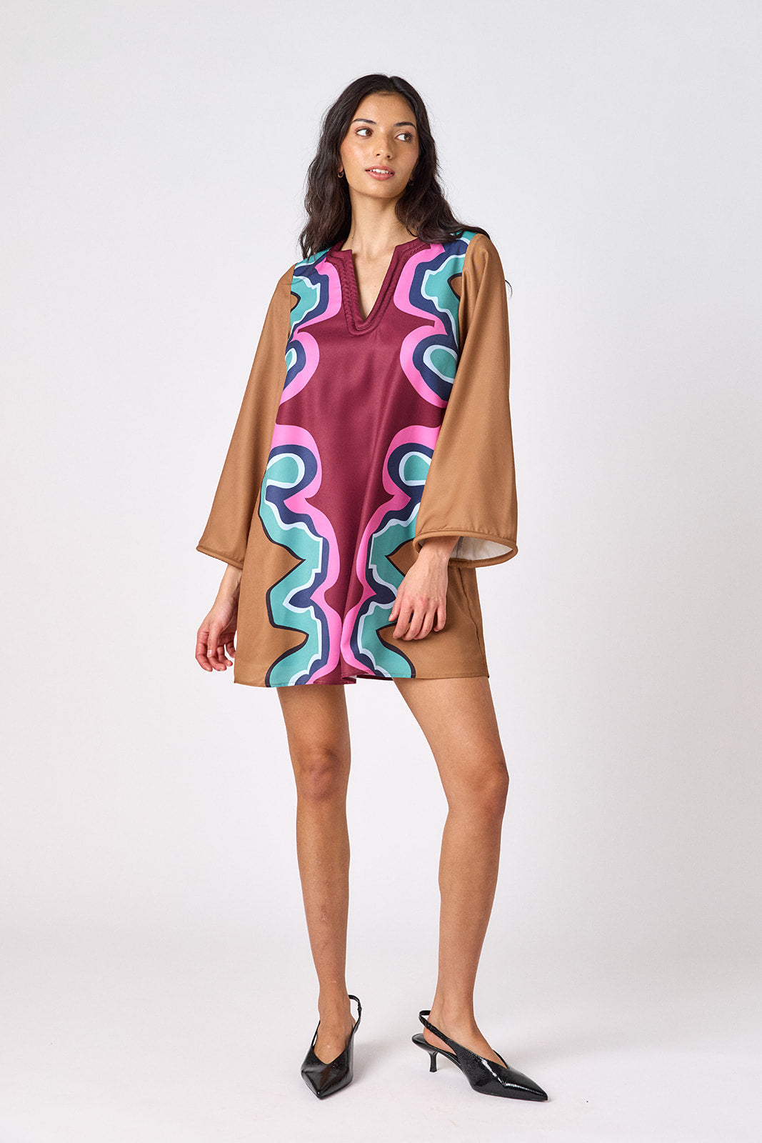 Serpentine above-the-knee tunic dress with bell sleeves on model – CROSBY by Mollie Burch
