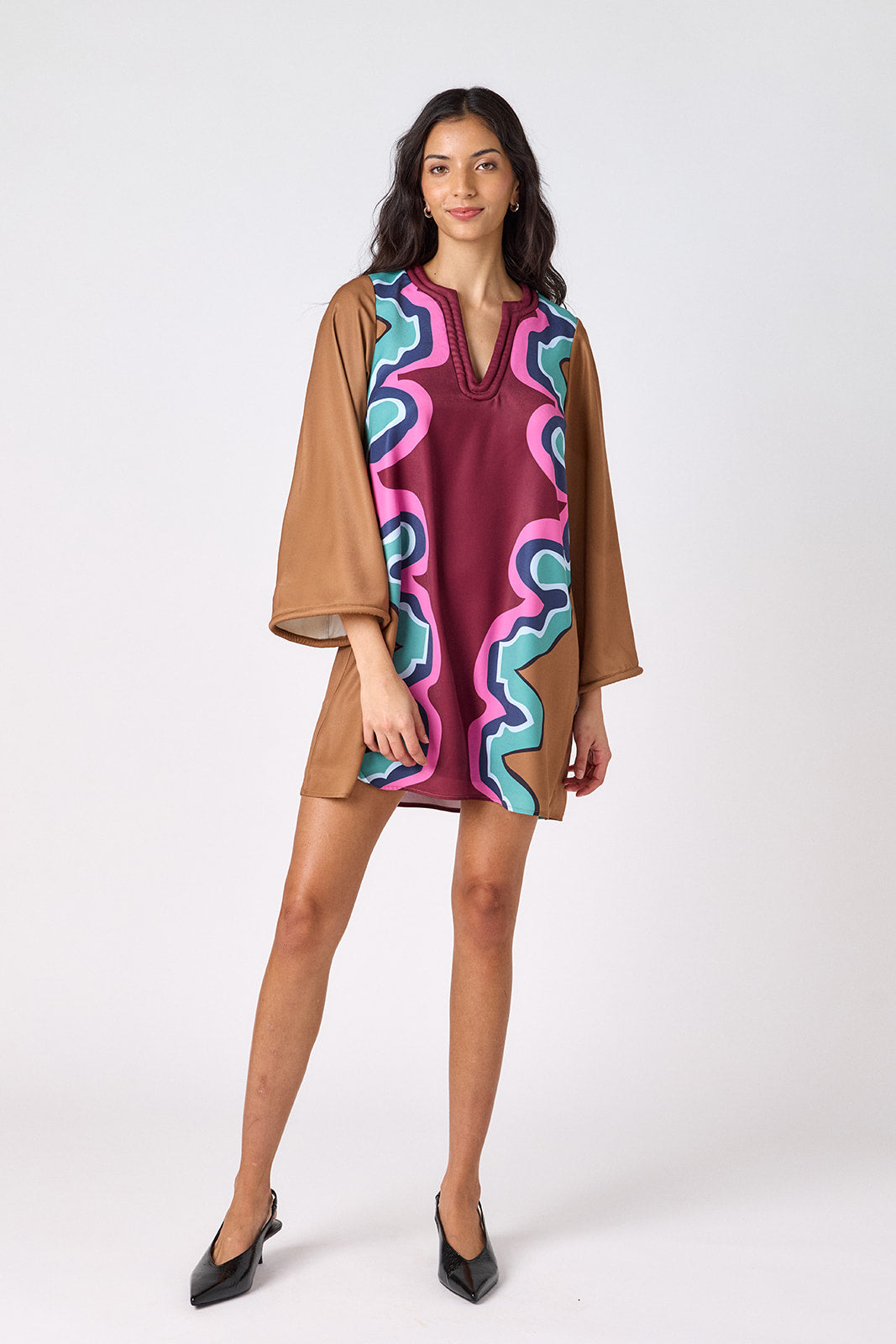 Serpentine above-the-knee tunic dress with bell sleeves on model – CROSBY by Mollie Burch