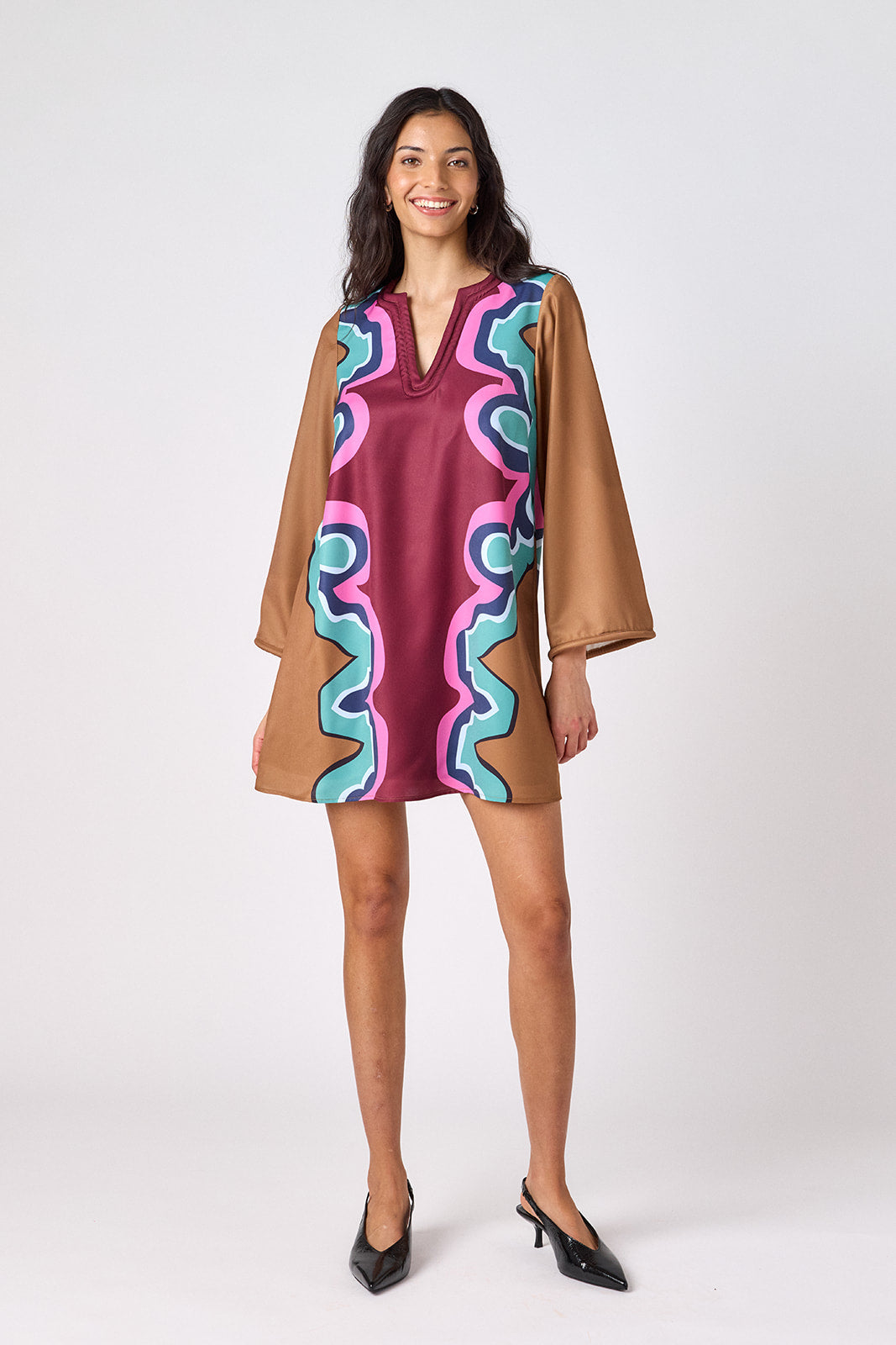 Serpentine above-the-knee tunic dress with bell sleeves on model – CROSBY by Mollie Burch