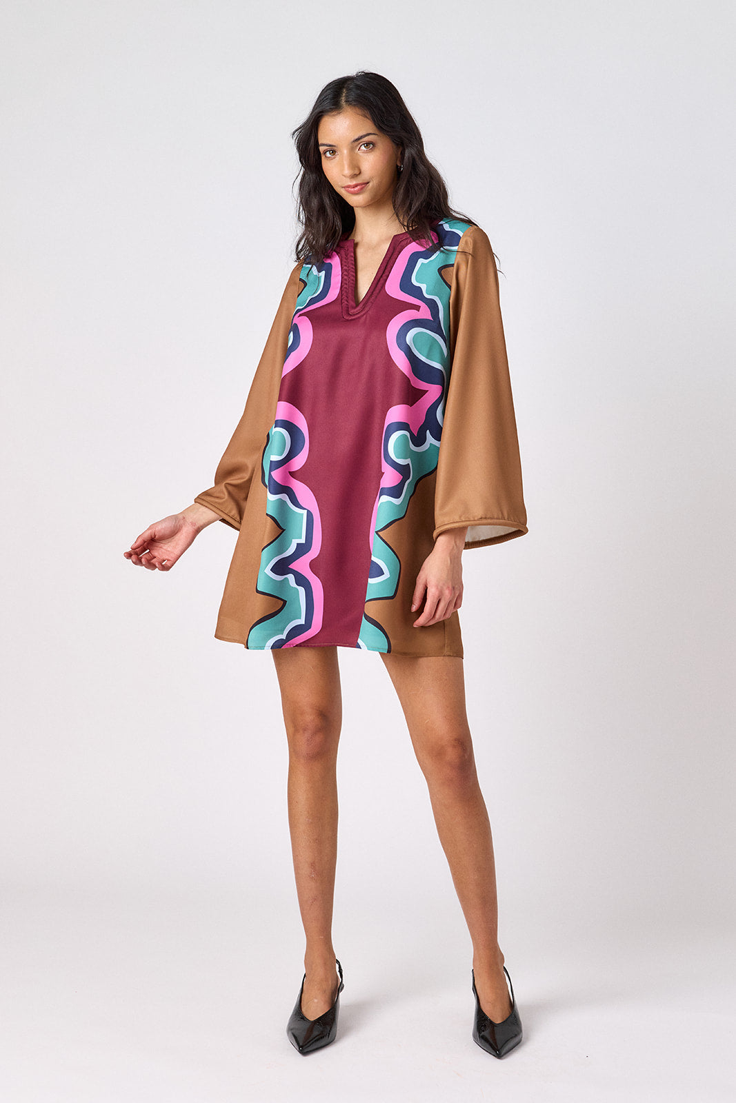 Serpentine above-the-knee tunic dress with bell sleeves on model – CROSBY by Mollie Burch