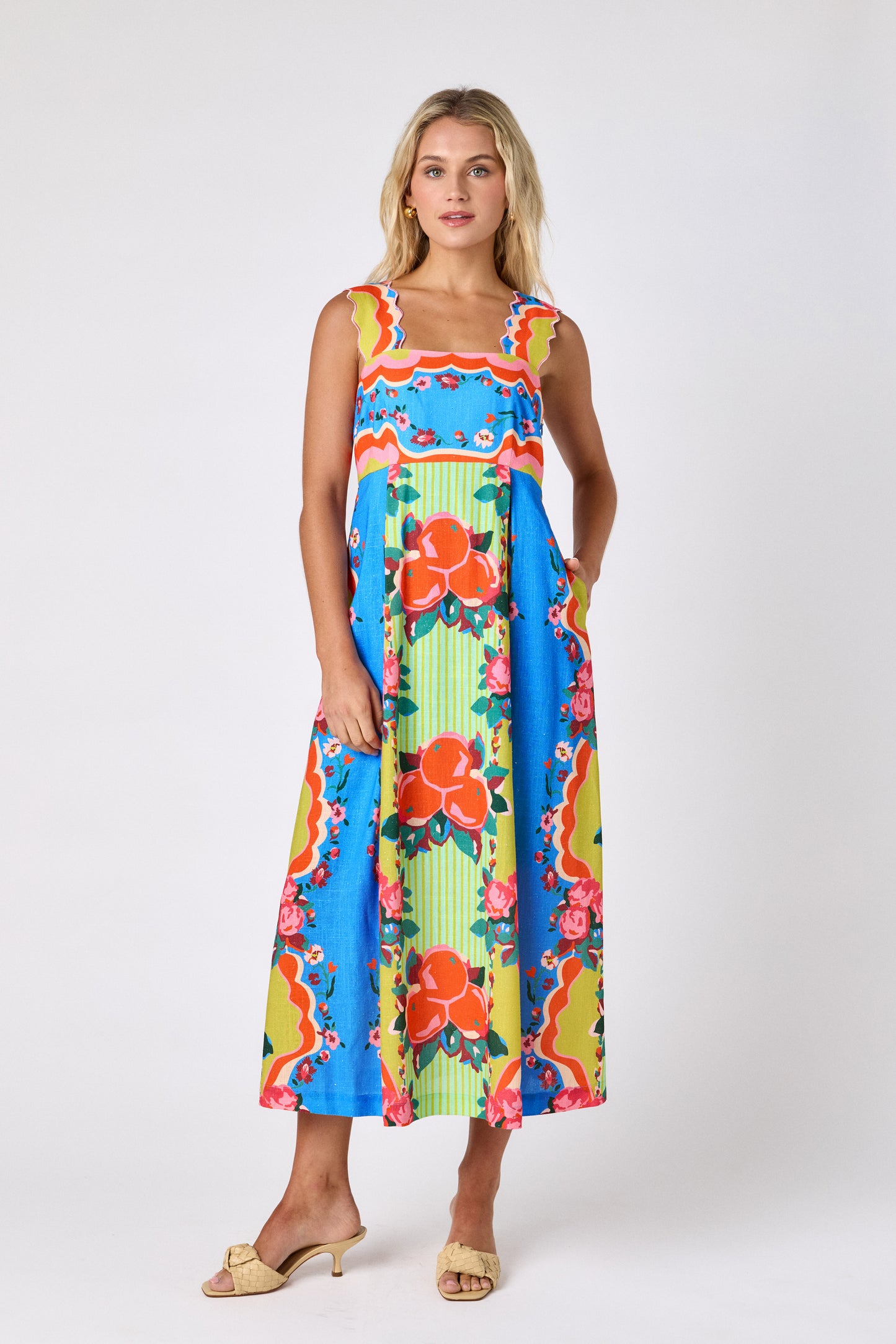 The Grove midi dress with fitted bodice and wavy straps on model — CROSBY by Mollie Burch