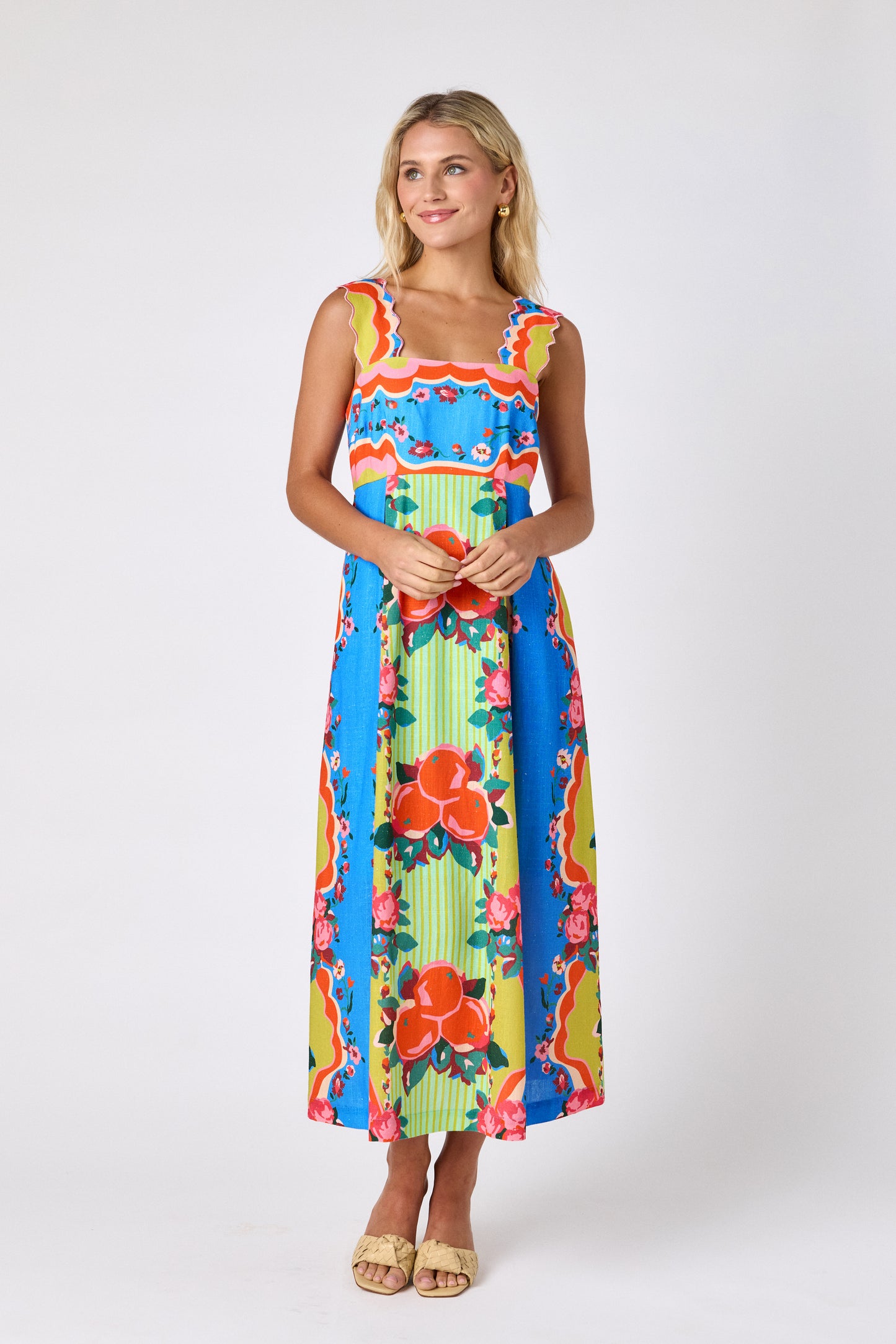 The Grove midi dress with fitted bodice and wavy straps on model — CROSBY by Mollie Burch