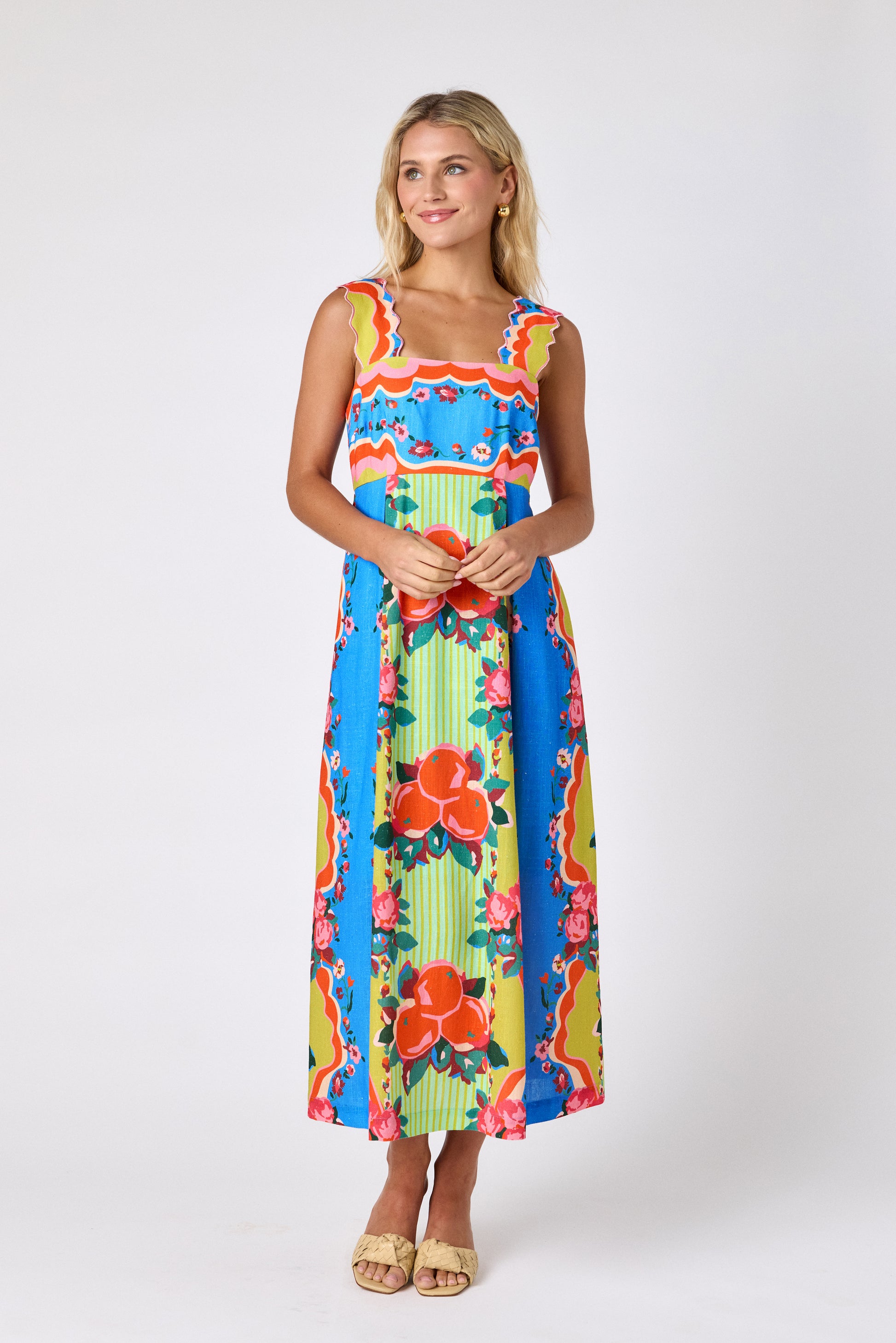 The Grove midi dress with fitted bodice and wavy straps on model — CROSBY by Mollie Burch