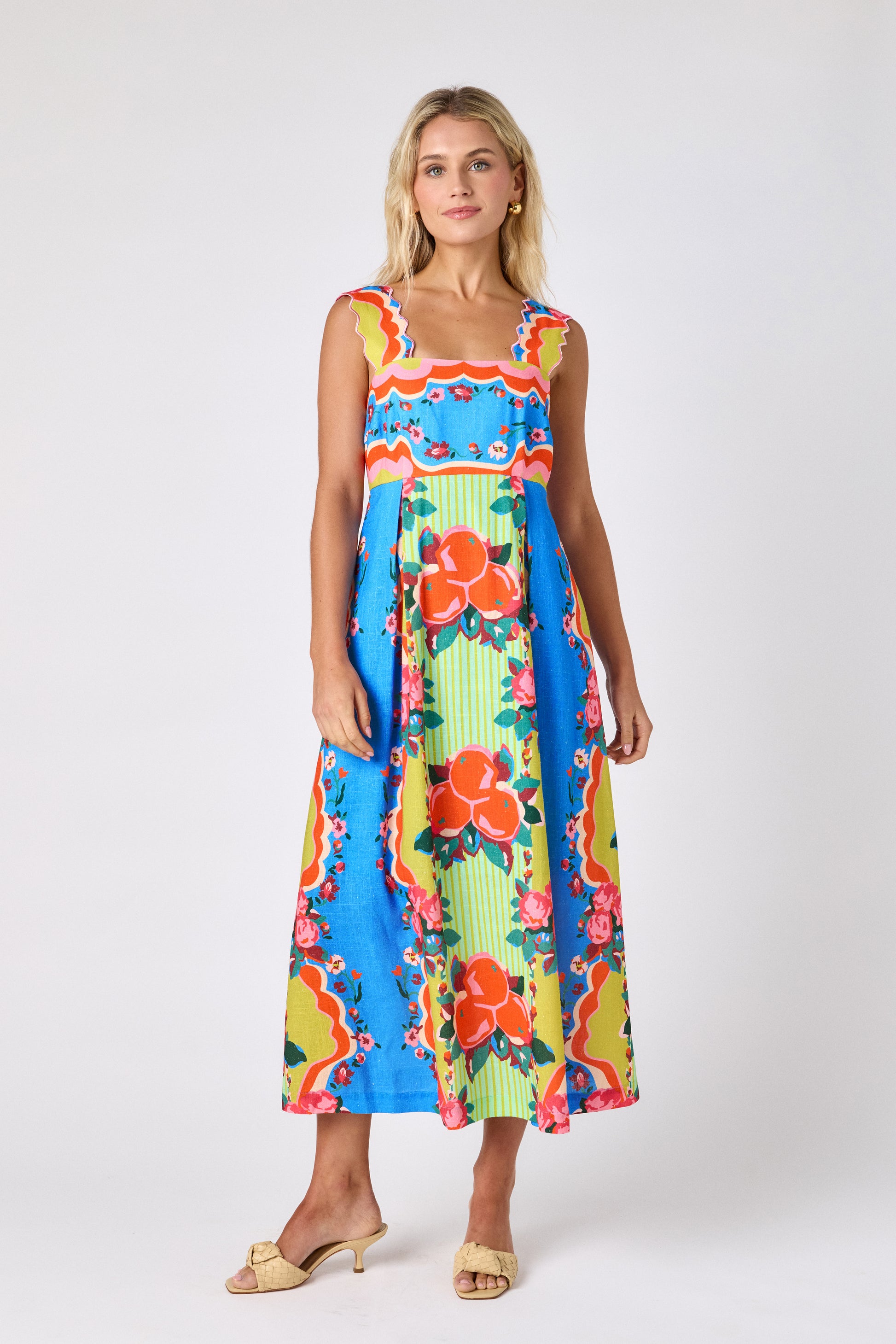 The Grove midi dress with fitted bodice and wavy straps on model — CROSBY by Mollie Burch