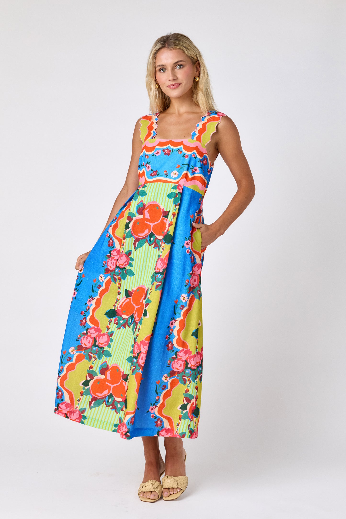 The Grove midi dress with fitted bodice and wavy straps on model — CROSBY by Mollie Burch