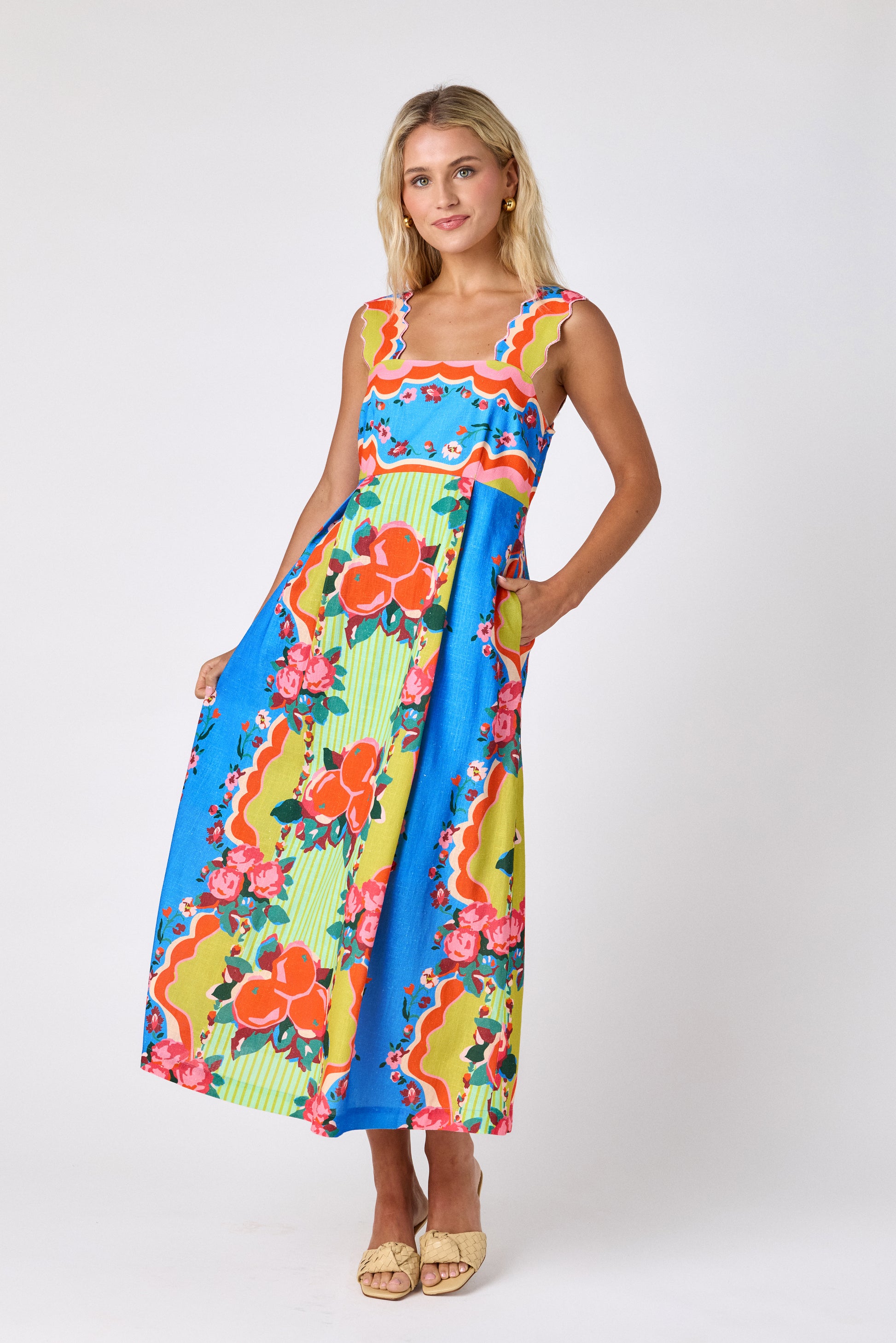 The Grove midi dress with fitted bodice and wavy straps on model — CROSBY by Mollie Burch