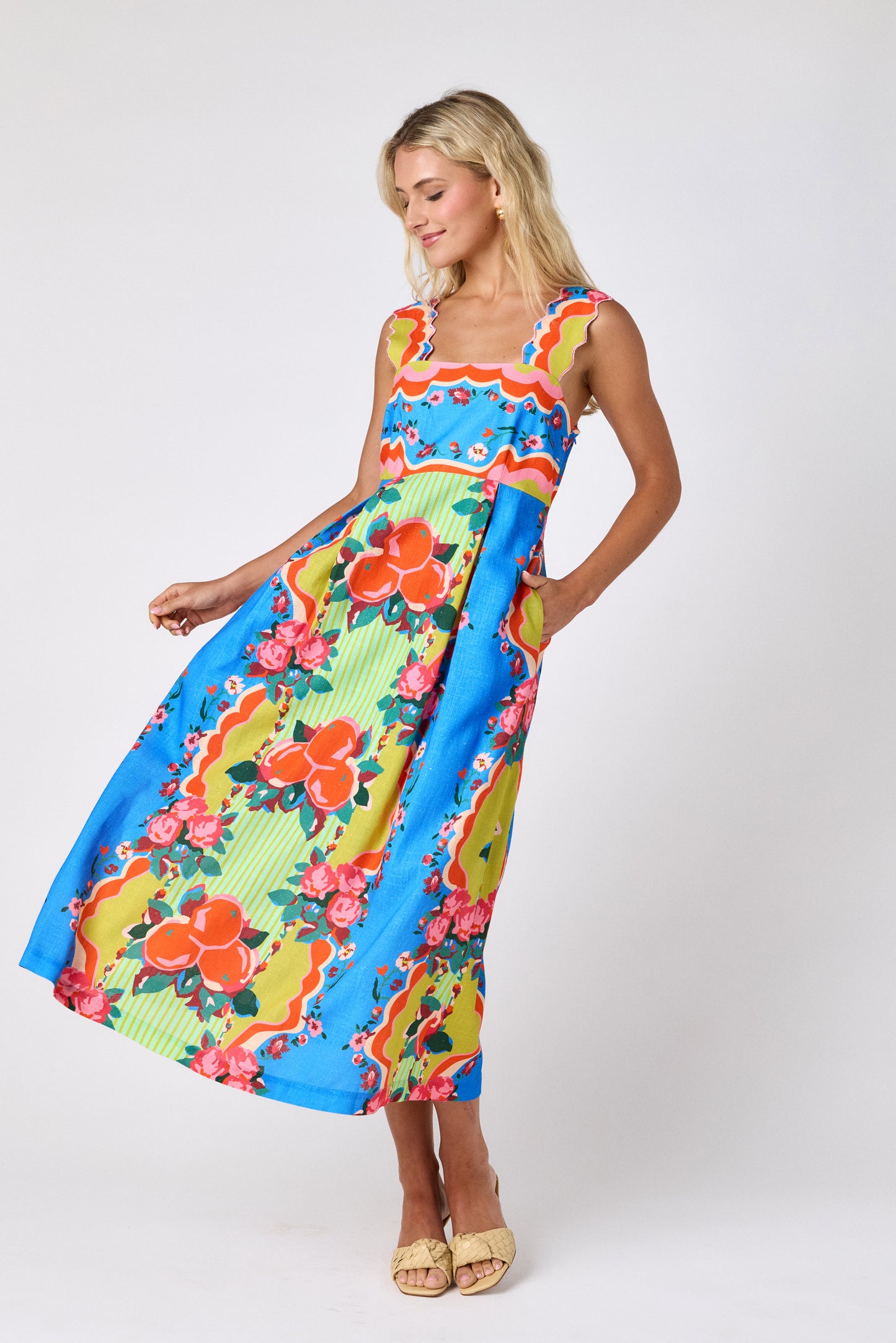 The Grove midi dress with fitted bodice and wavy straps on model — CROSBY by Mollie Burch