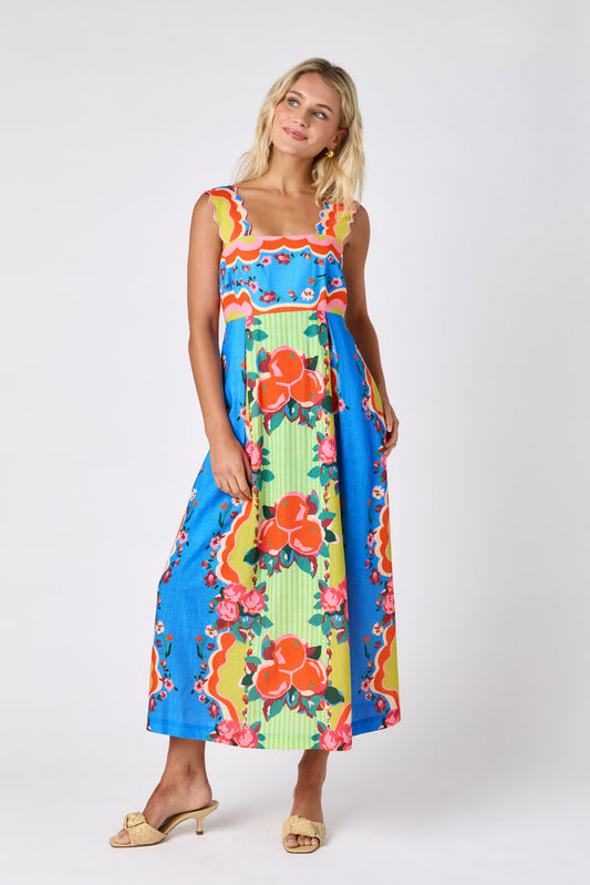The Grove midi dress with fitted bodice and wavy straps on model — CROSBY by Mollie Burch