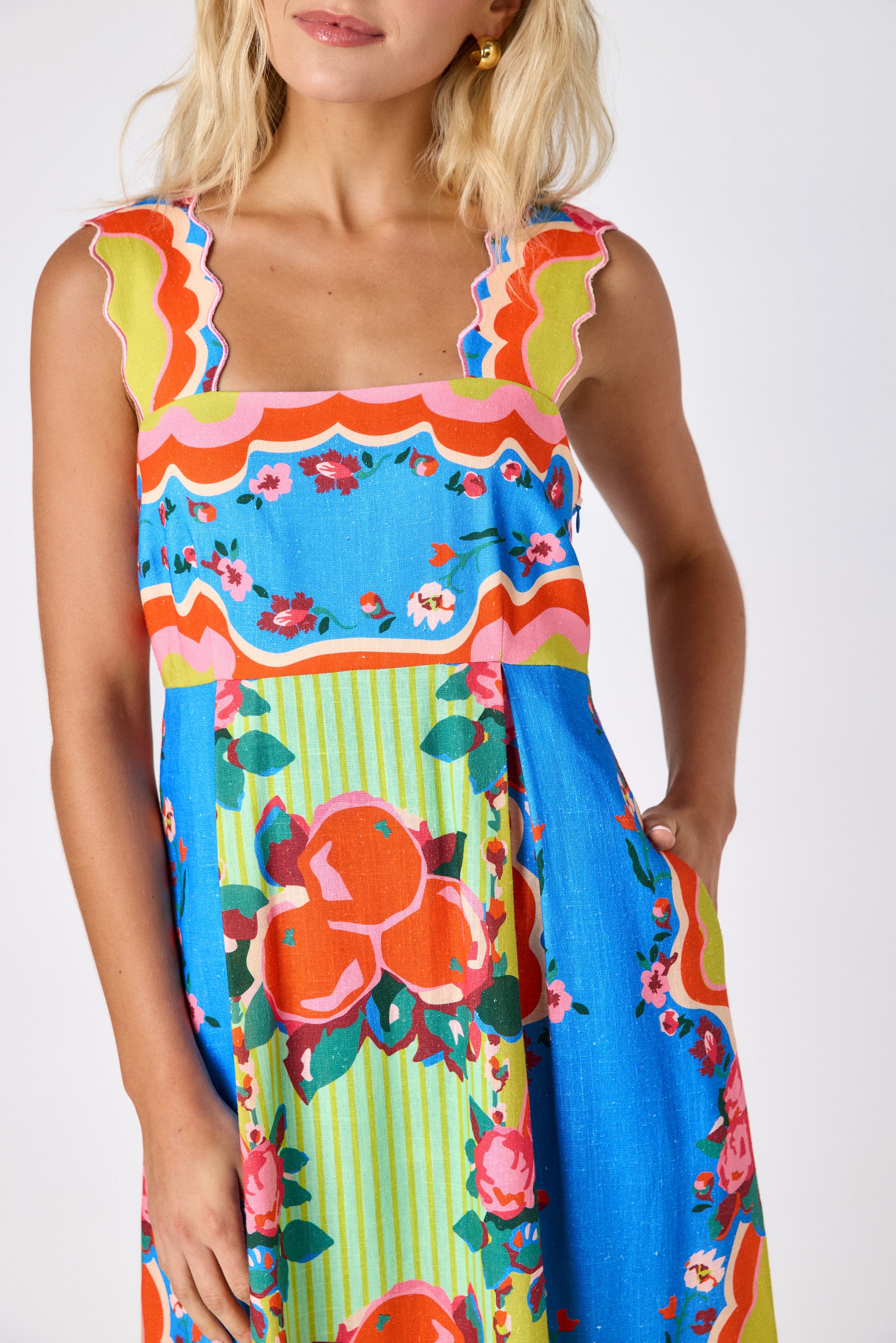 The Grove midi dress with fitted bodice and wavy straps on model — CROSBY by Mollie Burch