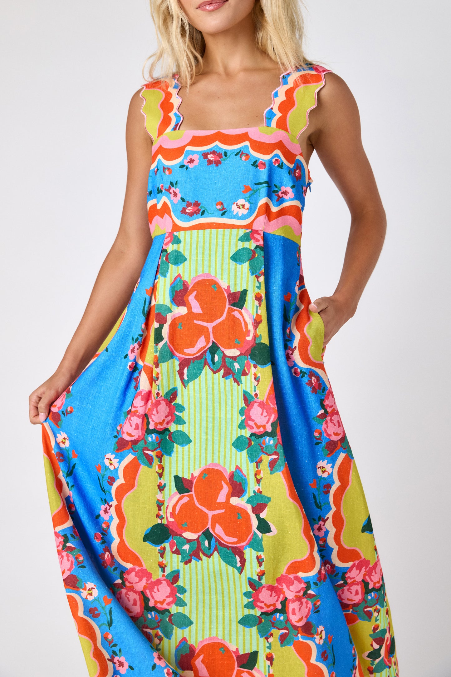 The Grove midi dress with fitted bodice and wavy straps on model — CROSBY by Mollie Burch