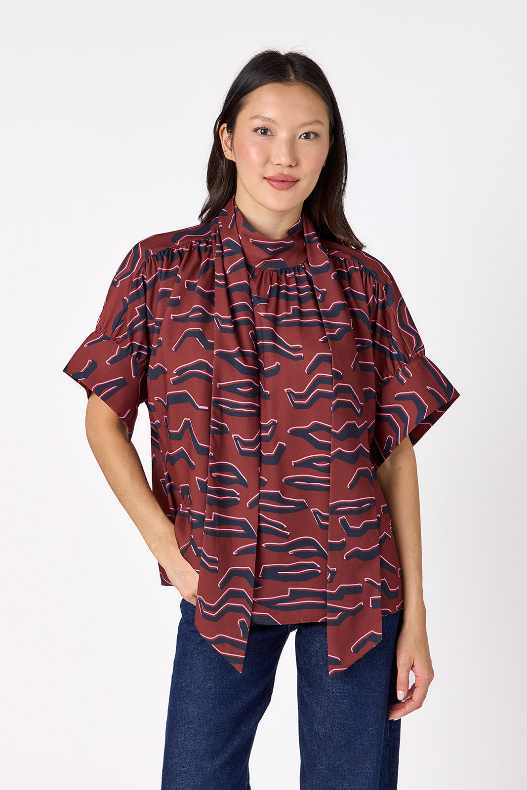 Lillian Top with short sleeves and versatile scarf detailing on model – CROSBY by Mollie Burch