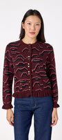 Sutton Cardigan in Tibetan Tiger featuring ruffle trim and front button detailing on model – CROSBY by Mollie Burch