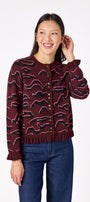 Sutton Cardigan in Tibetan Tiger featuring ruffle trim and front button detailing on model – CROSBY by Mollie Burch