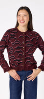 Sutton Cardigan in Tibetan Tiger featuring ruffle trim and front button detailing on model – CROSBY by Mollie Burch