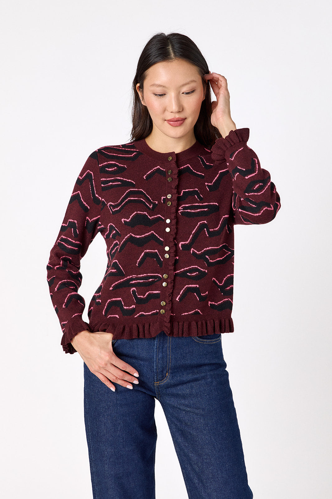 Sutton Cardigan in Tibetan Tiger featuring ruffle trim and front button detailing on model – CROSBY by Mollie Burch