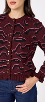 Sutton Cardigan in Tibetan Tiger featuring ruffle trim and front button detailing on model – CROSBY by Mollie Burch