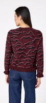 Sutton Cardigan in Tibetan Tiger featuring ruffle trim and front button detailing on model – CROSBY by Mollie Burch