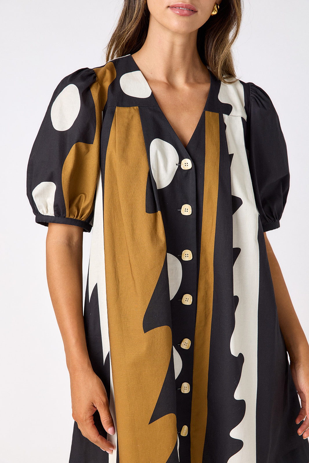 Wild Line v-neck dress with puff sleeves and a swingy silhouette on model — CROSBY by Mollie Burch