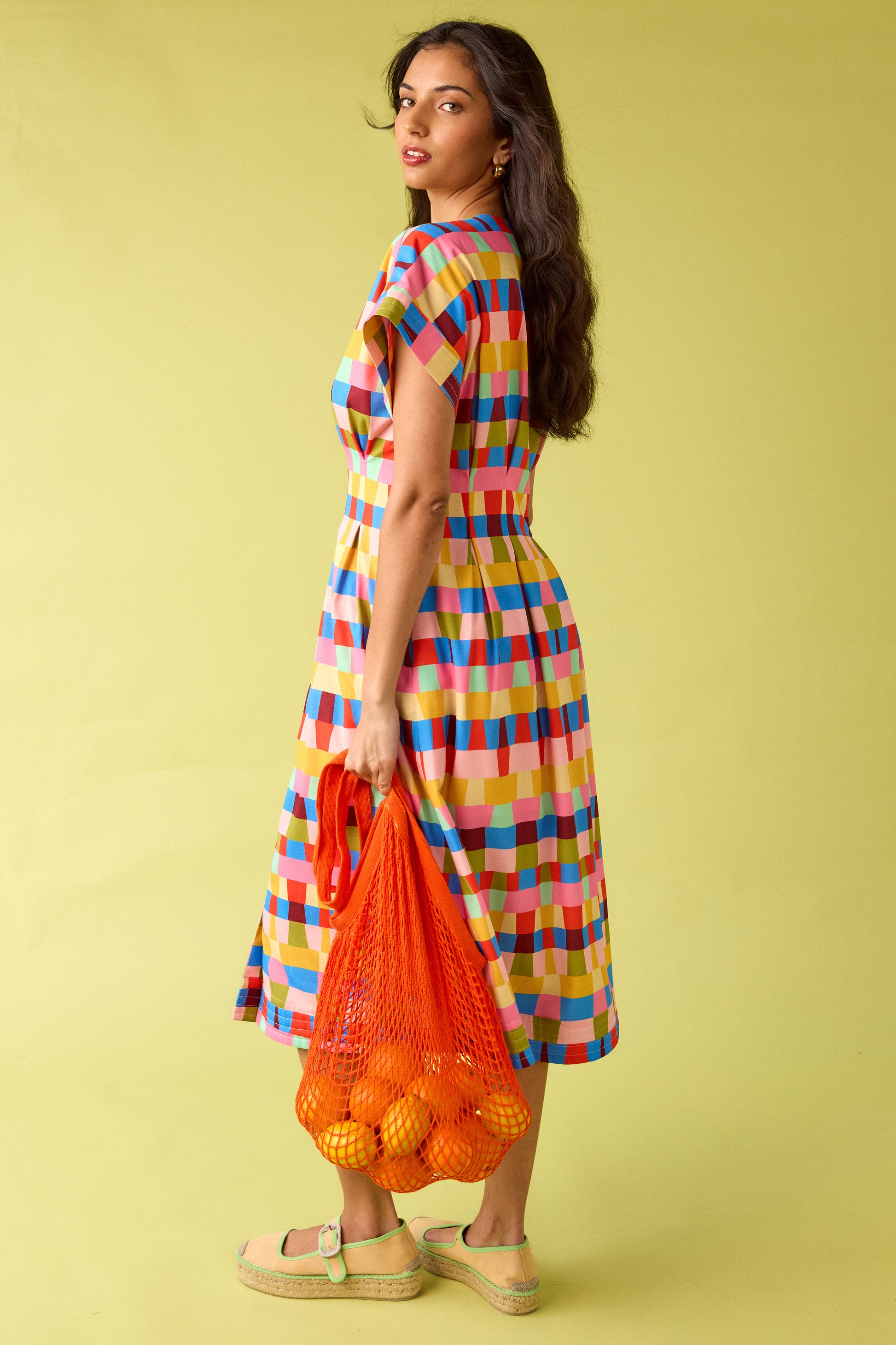 Prism short sleeved button-front midi dress with waist emphasis on model — CROSBY by Mollie Burch