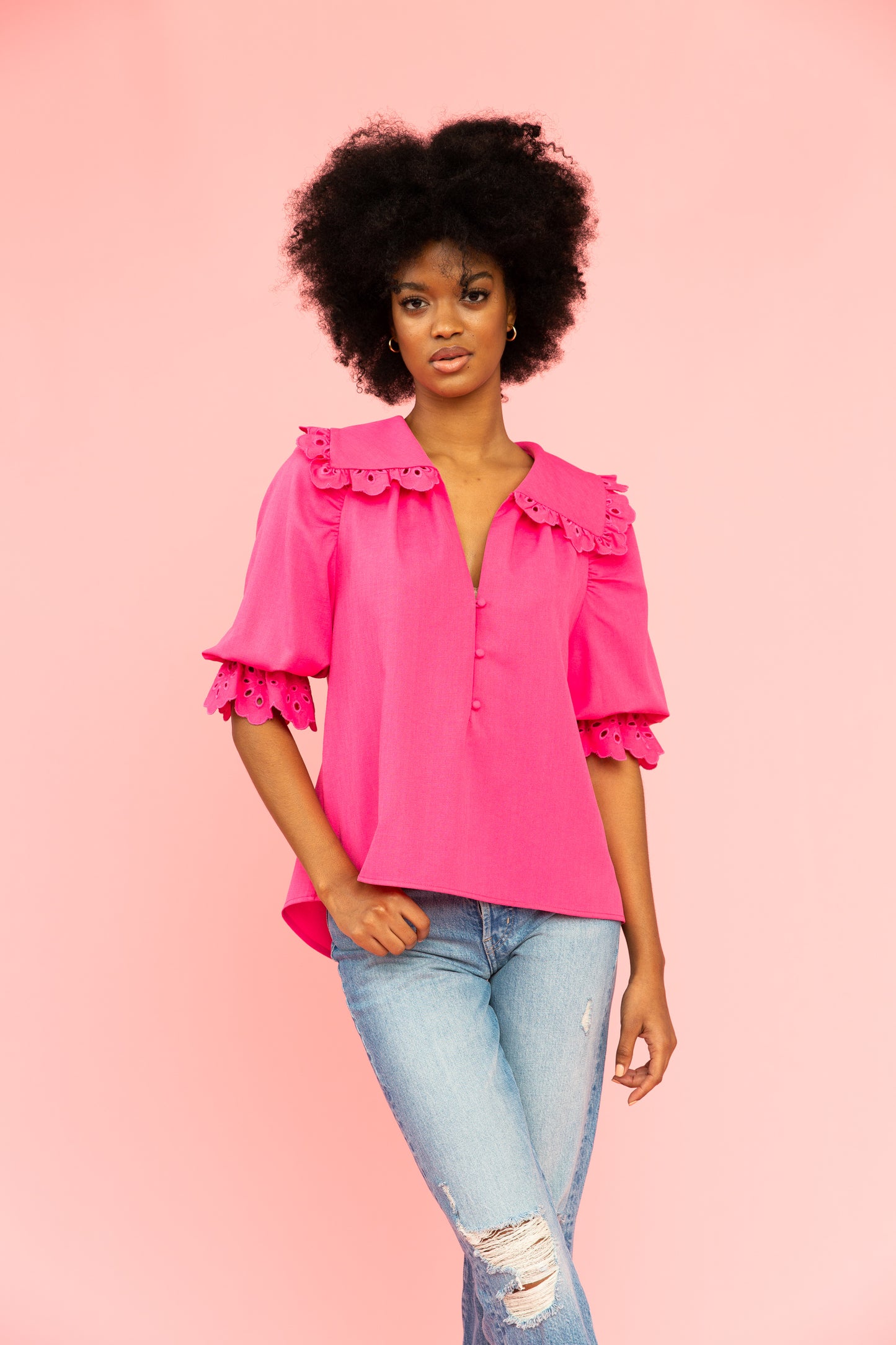Vivid pink blouse with eyelet details and collar with distressed jeans