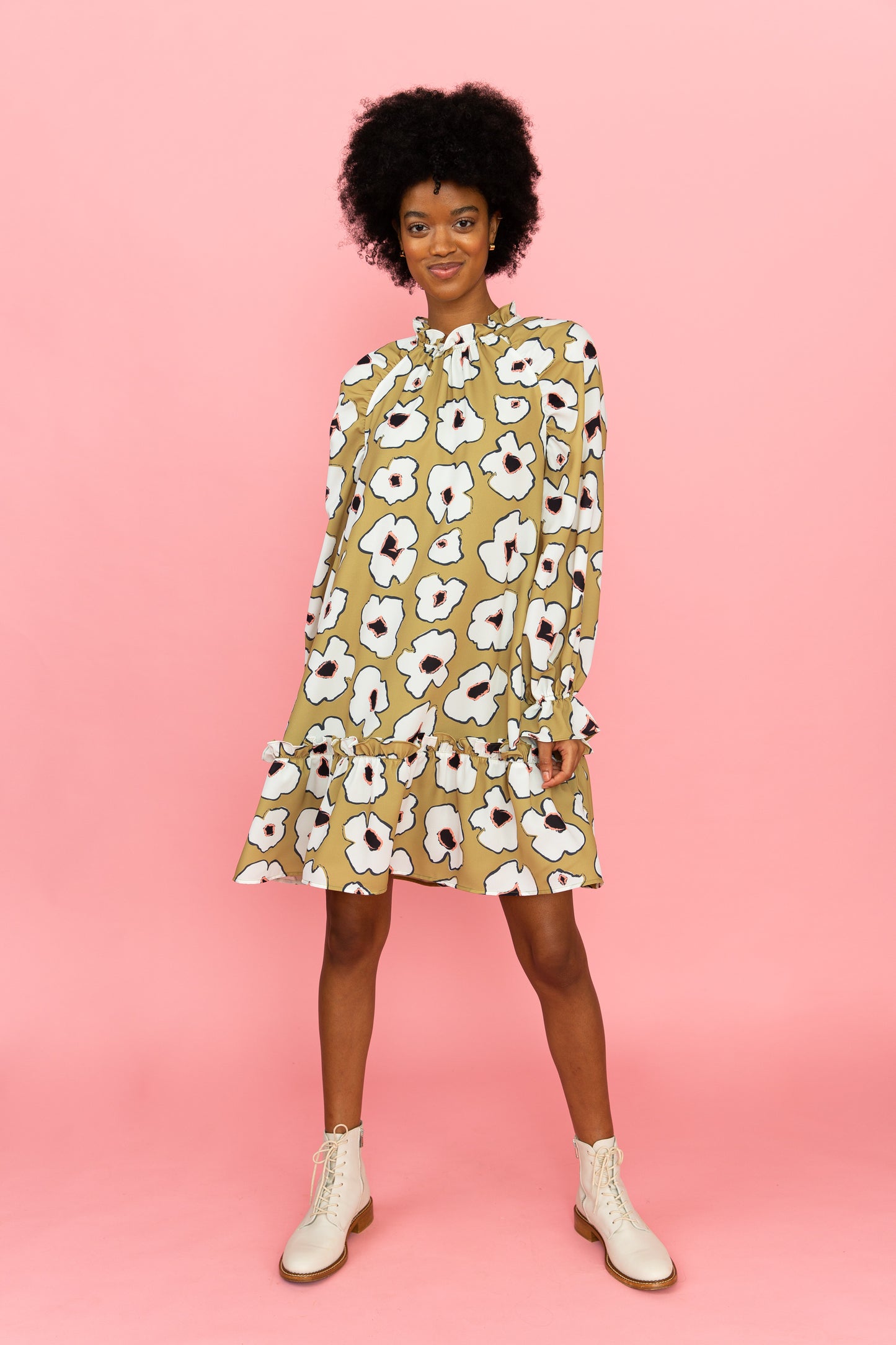 Long sleeved above-the-knee dress with white flowers on a green background