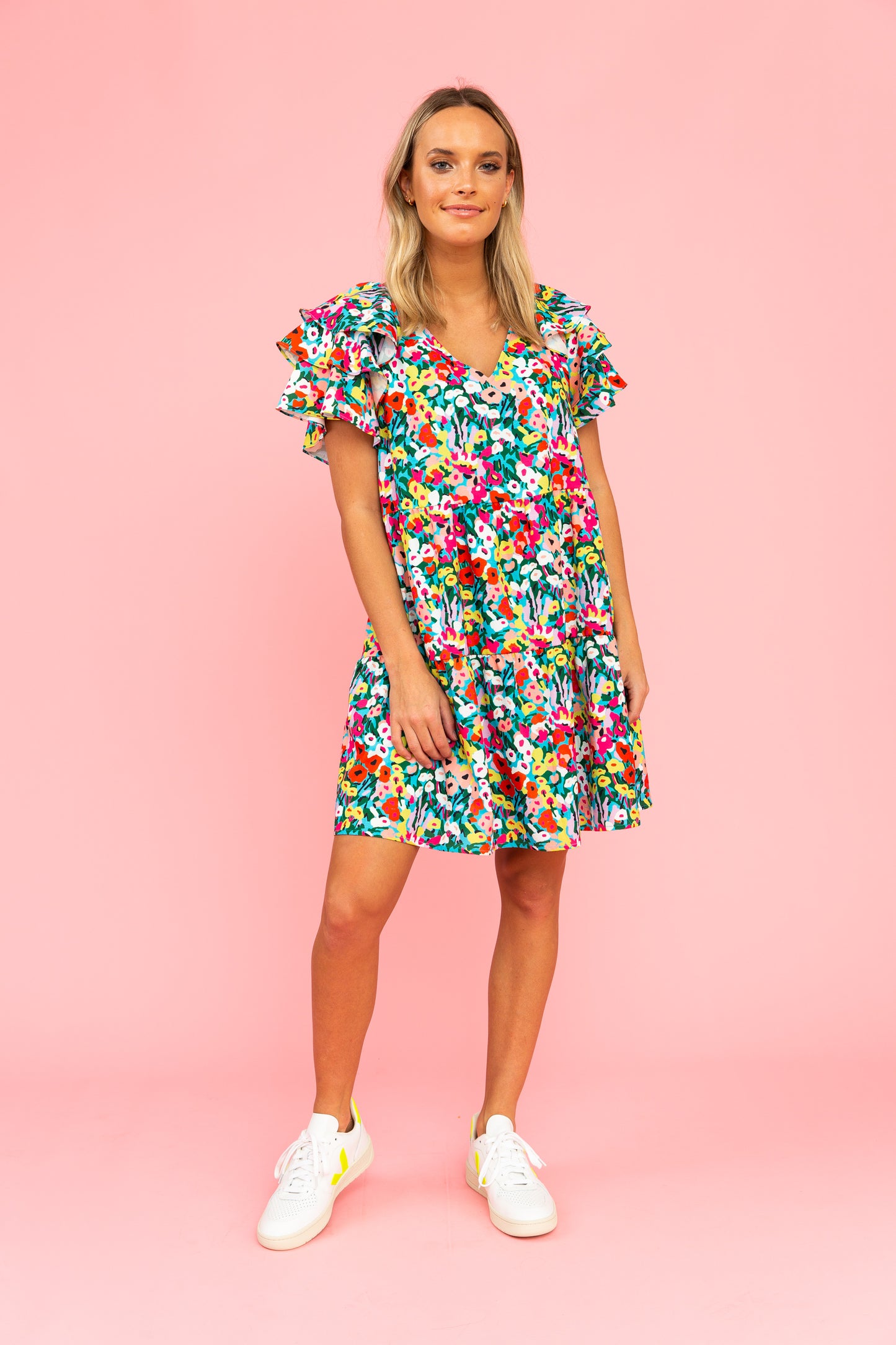 Brightly colored floral dress with v-neck and flutter sleeves