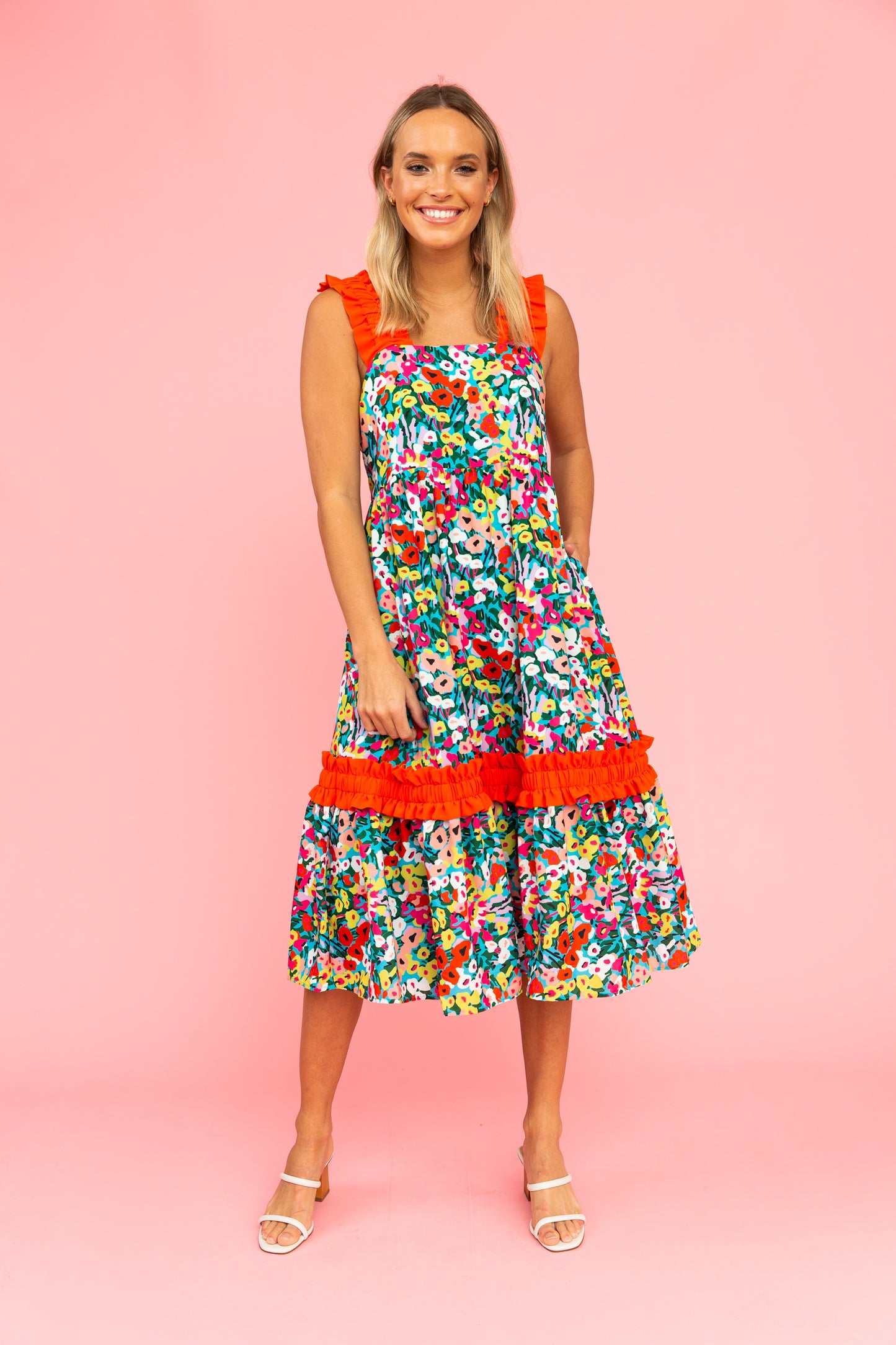 Brightly colored floral dress with red ruffled straps