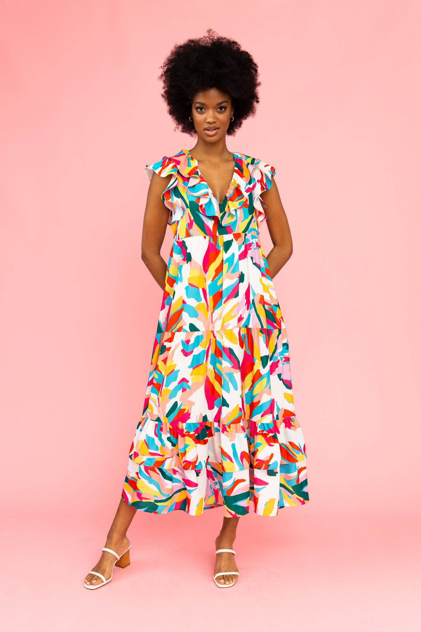 Brightly colored tiered maxi dress with flutter sleeves and ruffled v-neck detail