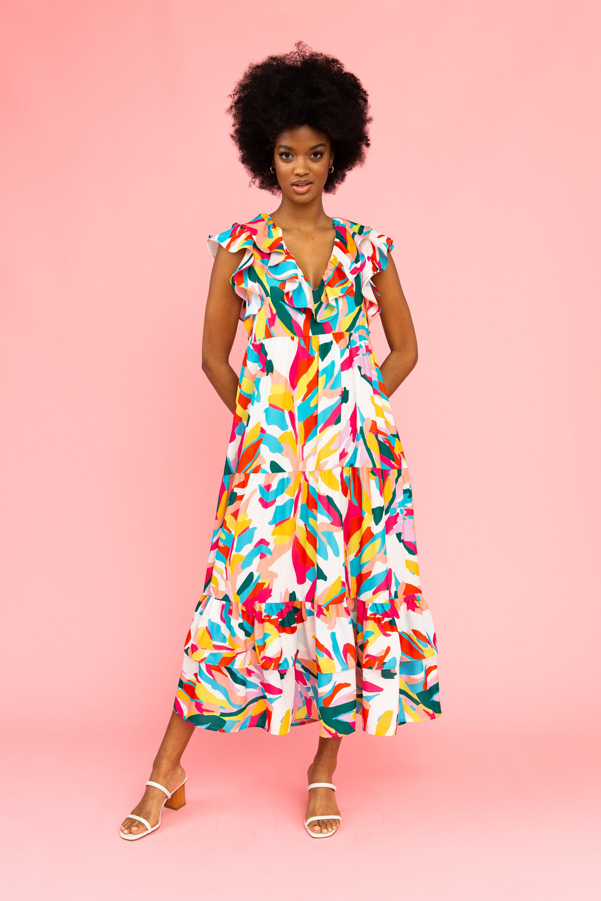 Brightly colored tiered maxi dress with flutter sleeves and ruffled v-neck detail