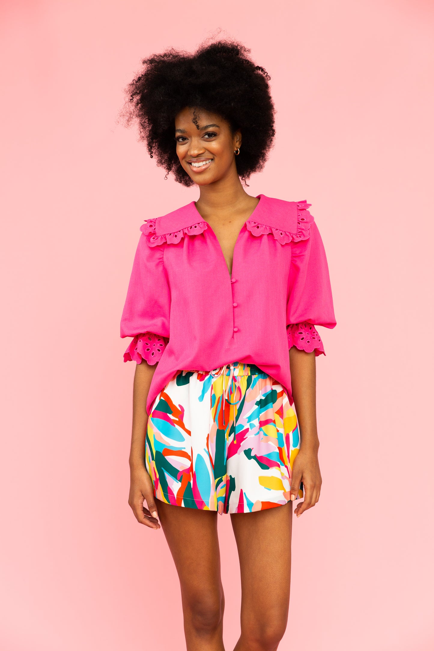Vivid pink top with collar and eyelet details with brightly colored shorts