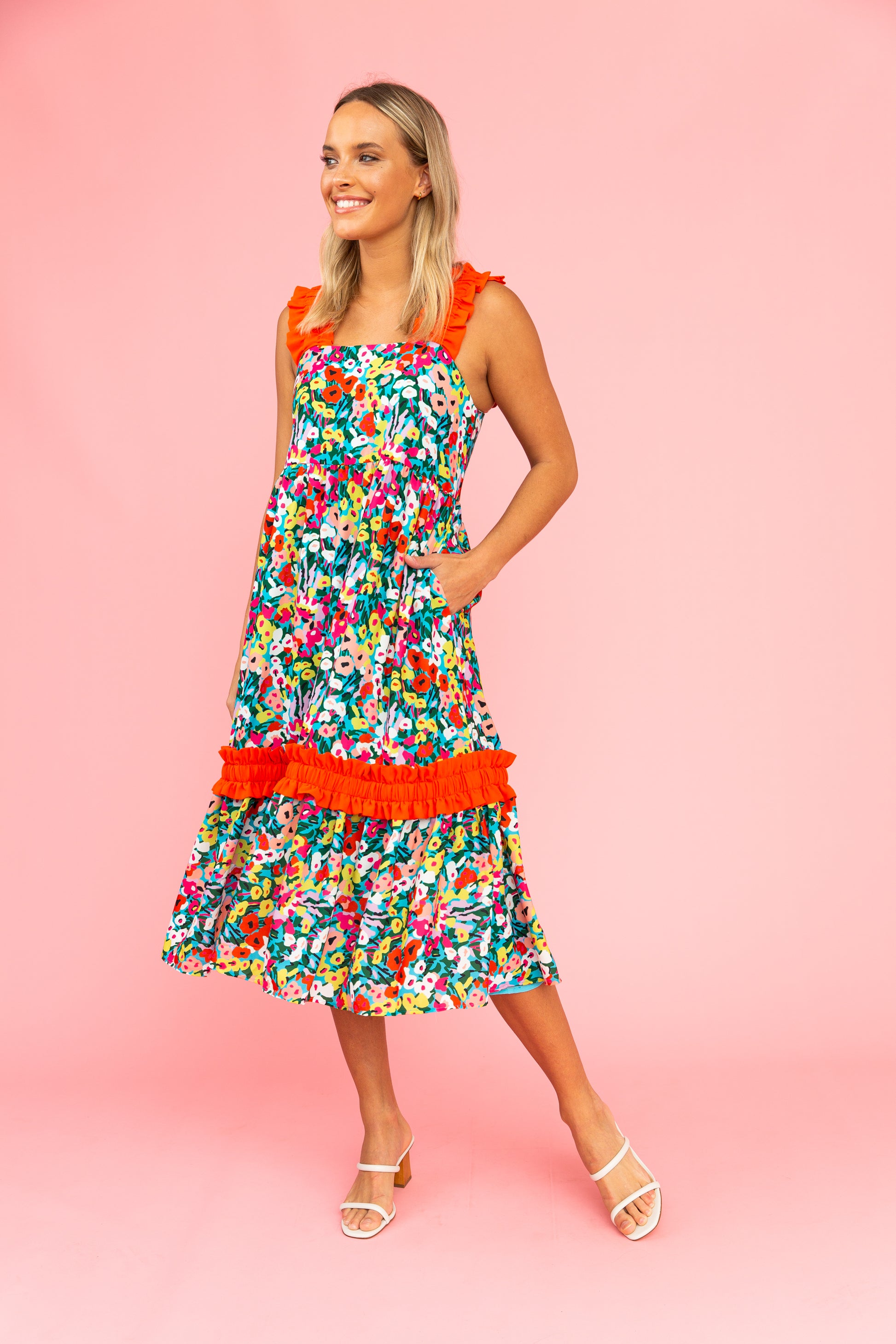 Brightly colored floral dress with red ruffled straps